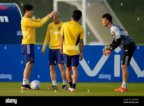 Japan's Daichi Kamada, left, touches head of Japan's Daizen Maeda ...