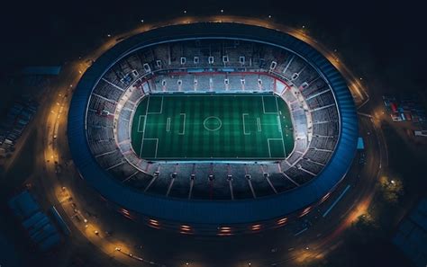 Premium AI Image | An aerial view of a stadium at night with lights on.