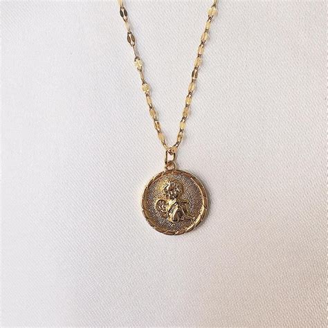 new! gold angel coin necklace part of our... - Depop