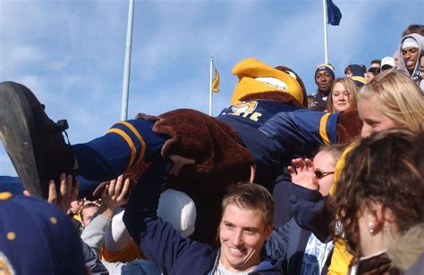 Flash, the Mascot of Kent State Sports, is passed through the crowd during a home football game ...