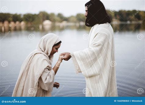 Shallow Focus Shot Of A Female Wearing A Biblical Gown While Holding The Hand Of Jesus Christ ...