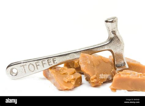 Broken Toffee and silver coloured toffee hammer isolated against white background Stock Photo ...