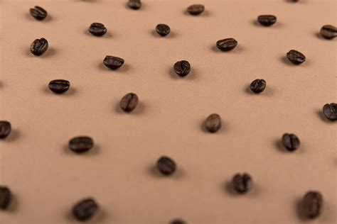 Black Coffee Beans on Brown Surface · Free Stock Photo