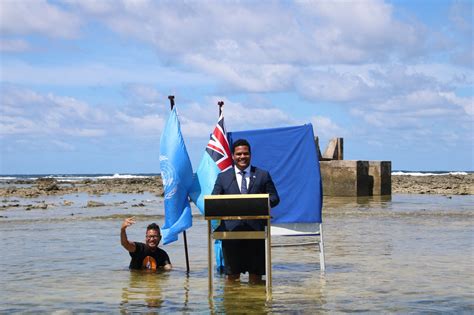 Tuvalu minister stands in sea to film COP26 speech to show climate change | Reuters