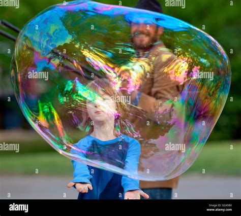 Boy Catching Large Soap Bubble Outdoors Stock Photo - Alamy