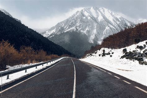 "Winter Road With A Snowy Mountains In The Background" by Stocksy Contributor "Blue Collectors ...