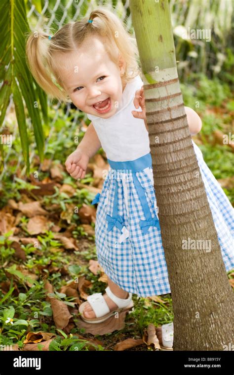 little girl playing hide & seek Stock Photo - Alamy