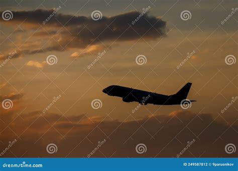 Silhouette of an Airplane Flying at Sunset Clouds. Stock Photo - Image ...