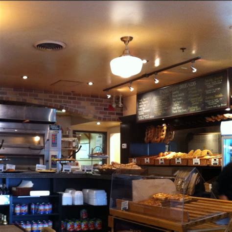 the inside of a restaurant with lots of food and drinks on display at the counter