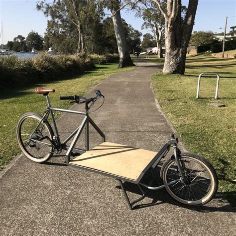 a bike with a ramp attached to it parked on the side of a road