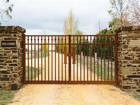 corten steel contemporary gate with stone pillar posts holcombe estate ...