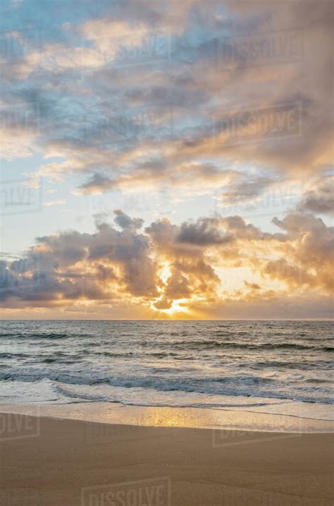 Sunrise over ocean on beach - Stock Photo - Dissolve