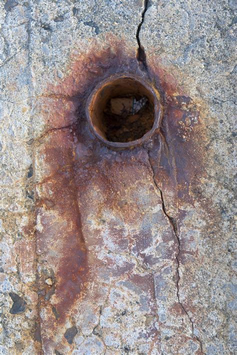 Rusted metal pipe in cracked concrete | An interesting color… | Flickr