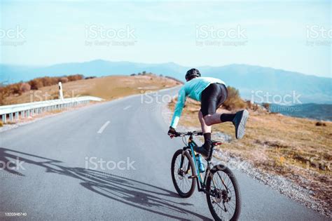 Male Performing Bicycle Tricks While Riding Downhill On Asphalt Road ...