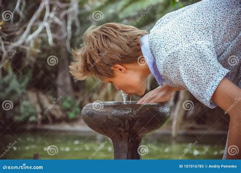 Boy Drinking Water from a Fountain Stock Image - Image of quenching, person: 107016785