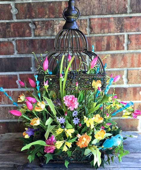 Beautiful summer/spring floral arrangement in a birdcage visit www.facebook.com/southernsass ...