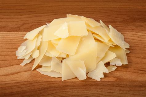 Shaved Parmesan Cheese on a wood cutting board - Stock Photo - Tony's Meats & Market