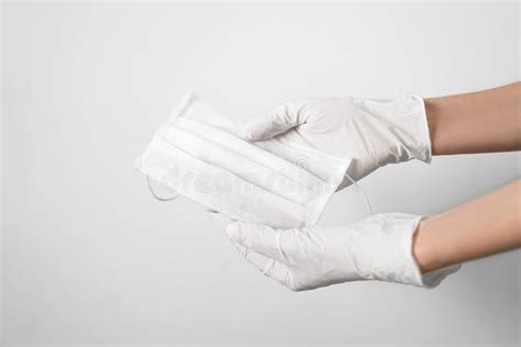 Hand with a Medical Face Mask and Medical Gloves for Protection Against ...