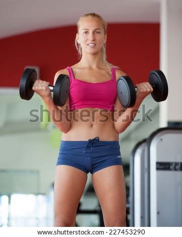 Push-ups woman with dumbbells workout fitness club at weightlifting gym - Stock Image - Everypixel