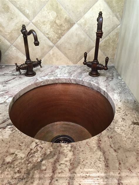 An elegant undermounted round copper bar sink in Cafe Natural, and Graff Vista faucet | Photo ...