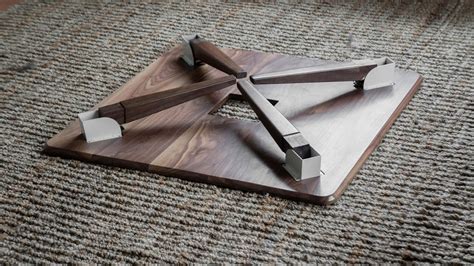 Foldable legs on a walnut coffee table for easy assembly and portability. https://ift.tt/2Qsh70m ...