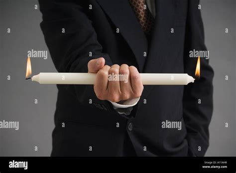 Burning the candle at both ends Stock Photo - Alamy