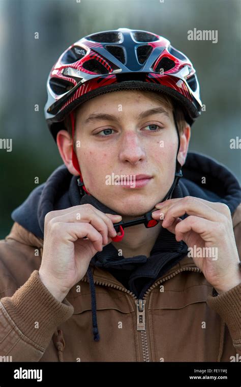 Cyclist put on safety clothing, bike helmet and reflecting vest for ...