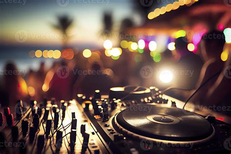 Dj mixing outdoor at beach party festival with crowd of people in background - Summer nightlife ...