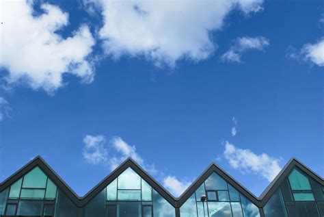 Grey Wood and Glass House Under Blue Sky and Clouds during Daytime · Free Stock Photo