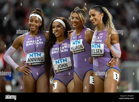 Amber Anning,Nicole Yeargin, Laviai Nielsen,Ama Pipi with her country's flag in the 4x400 meter ...