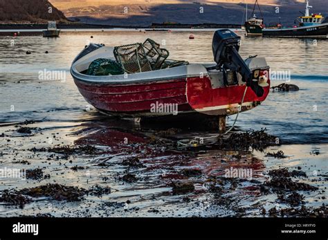 Small dinghy with outboard motor anchored in Portree Harbour, Isle of ...