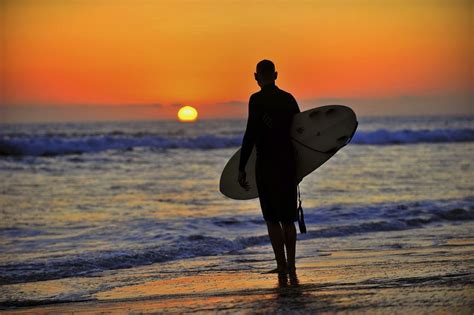 Surfer pauses to watch the sunset in Oceanside- August 19, 2012 ...