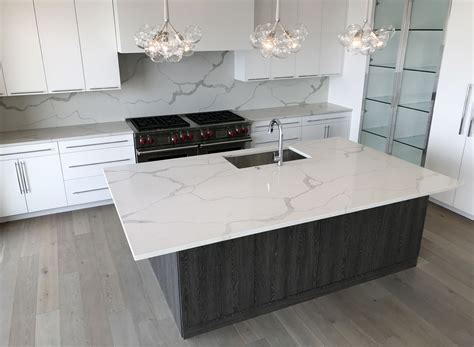 ColorQuartz Calacatta Novus Kitchen island and bar area with full height backsplash… | Quartz ...