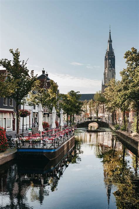 View Over The Canal In Delft With A Church In The Background | Stocksy ...