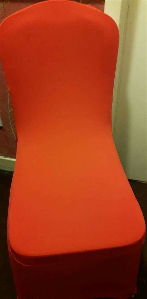 an orange chair sitting in front of a door