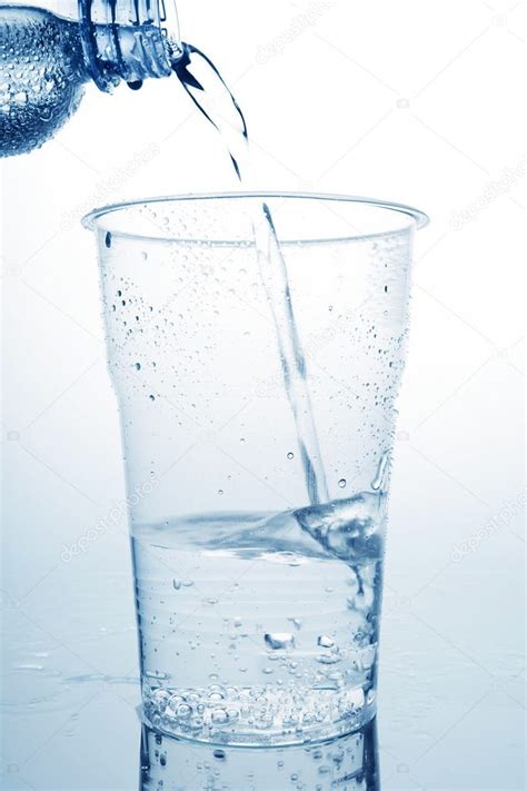 Water pouring in plastic cup — Stock Photo © VaakaF #3892633