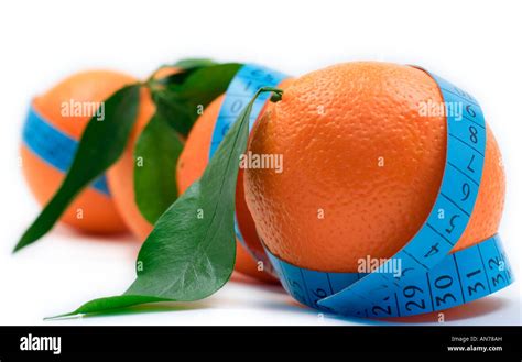 Oranges wrapped around a measurement tape Stock Photo - Alamy