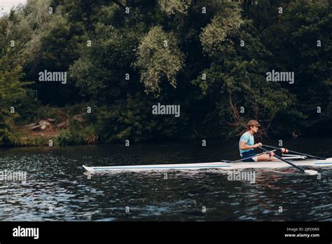 Sportsman single scull man rower rowing technique on boat. Paddle oar splash movement Stock ...