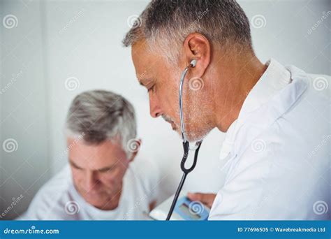 Doctor using stethoscope stock image. Image of citizen - 77696505