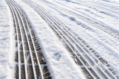 Car Tire Tracks In Snow On Street Stock Image - Image of cold ...