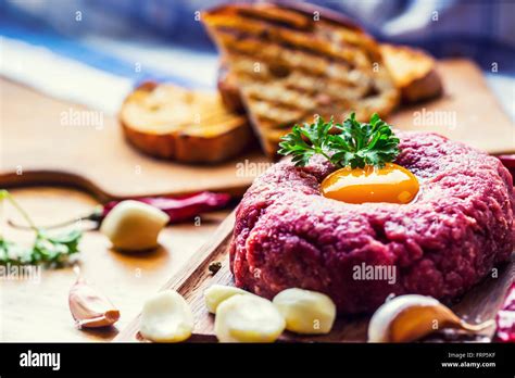 Raw beef .Tasty Steak tartare. Classic steak tartare on wooden board ...