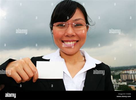 Business woman holding a business card Stock Photo - Alamy