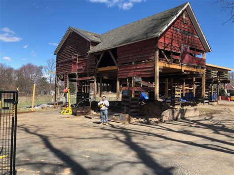 This historic barn was lifted to allow for the existing compromised foundation to be removed and ...