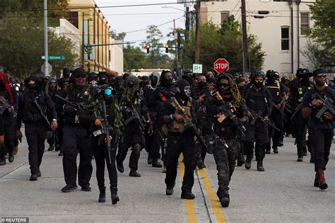 Domi Good: Hundreds of members of black militia raise their guns while holding an armed rally in ...