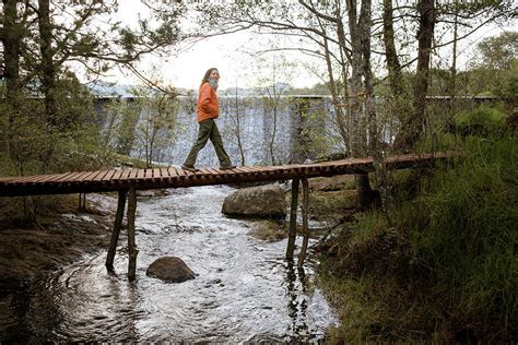 Woman Walking On Wooden Bridge Photograph by Marcos Ferro