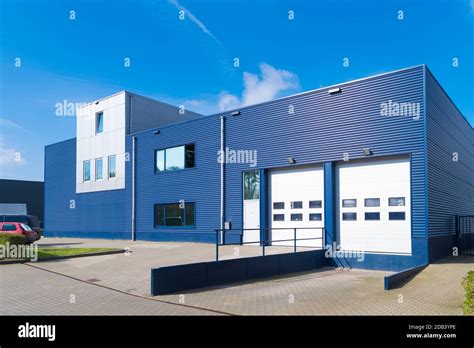 exterior of a modern warehouse with a small office unit Stock Photo - Alamy