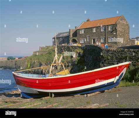 A traditional wooden coble fishing boat and the harbour, Craster Stock Photo, Royalty Free Image ...