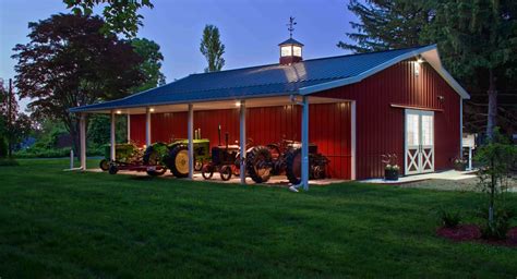 Red pole barn with porch and lighting | Barn house kits, Building a pole barn, Pole barn house cost