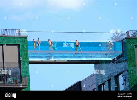 London, UK. Swimmers at the newly-opened Sky Pool at Embassy Gardens ...