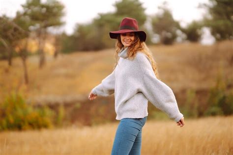 Premium Photo | Stylish woman in hat enjoying autumn weather in the park fashion style concept